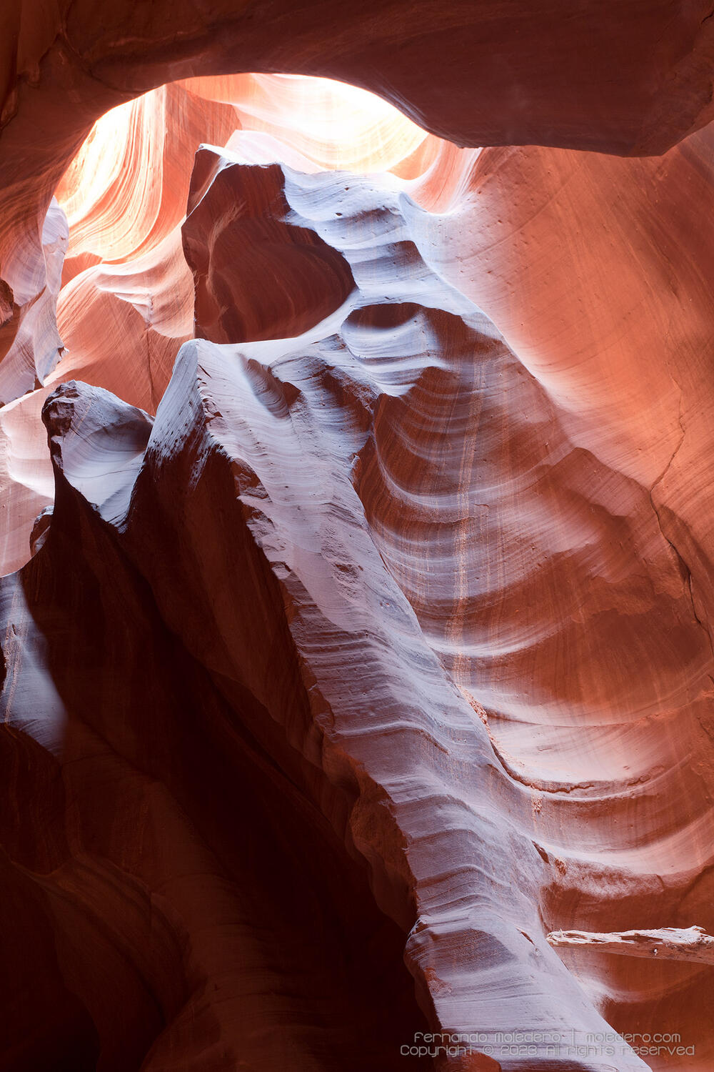 Detailed view of curved sandstone walls in Antelope Canyon, Arizona, USA, with smooth textures, layered patterns and warm light illuminating the red rock formations